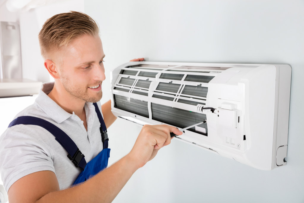 HVAC technician performing ductless air conditioning maintenance in Broomfield