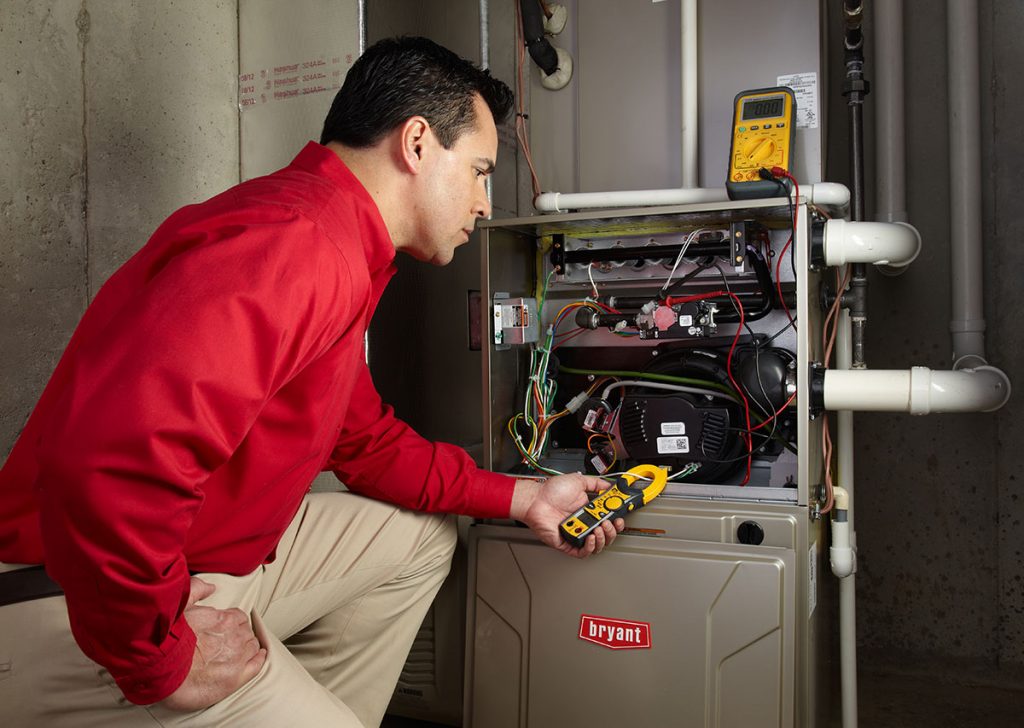 HVAC technician repairing an indoor furnace in Broomfield