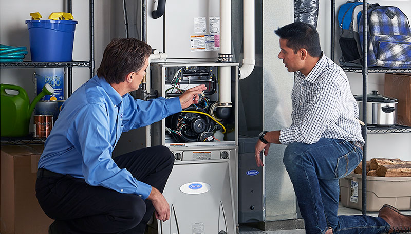 HVAC technician evaluating a furnace for repair or replacement in Broomfield
