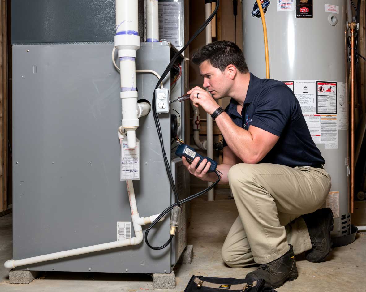 HVAC technician performing a furnace tune-up in Broomfield