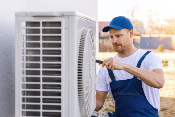 HVAC technician servicing an outdoor air conditioning unit in Broomfield