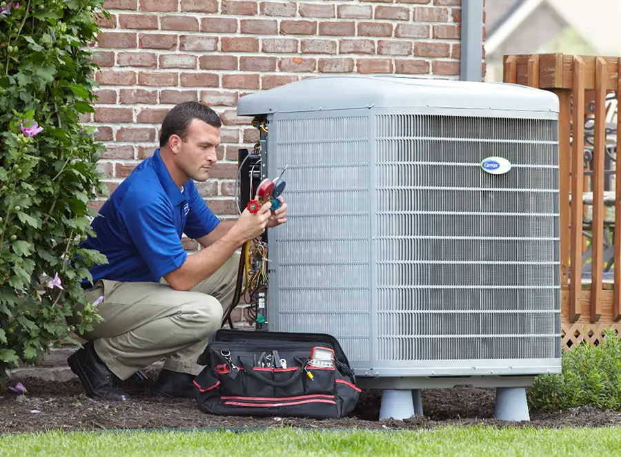 HVAC technician inspecting an outdoor air conditioning unit in Broomfield