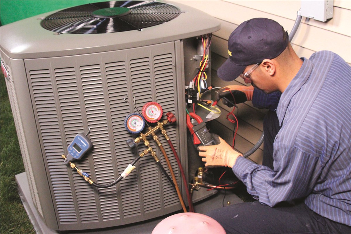 HVAC technician testing an outdoor air conditioning unit in Broomfield